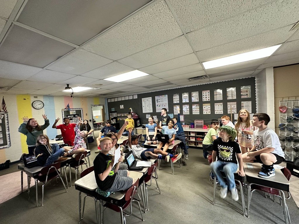 students sitting on desk for flood drill