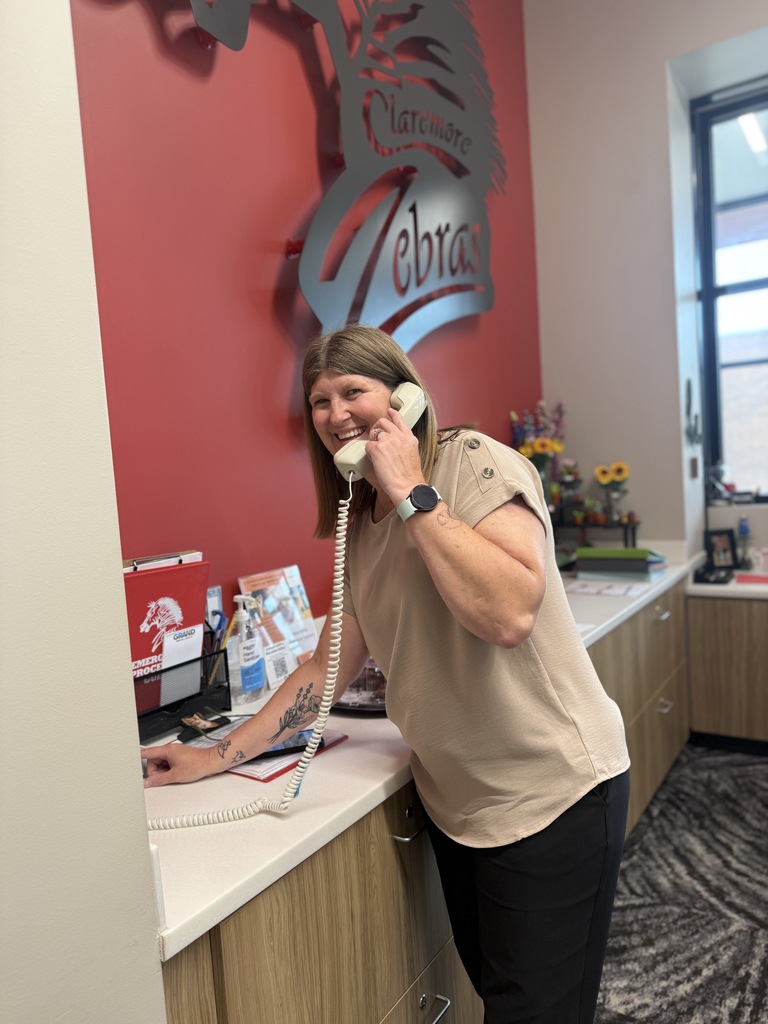 Ms Jenni smiling while calling on the intercom 