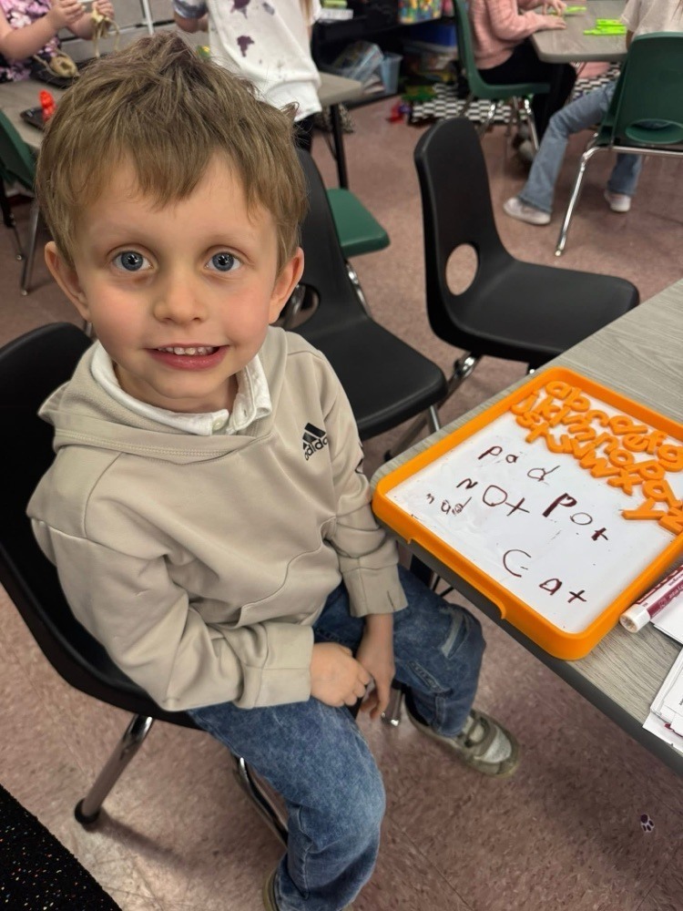 elementary students learning about vowels and consonants.