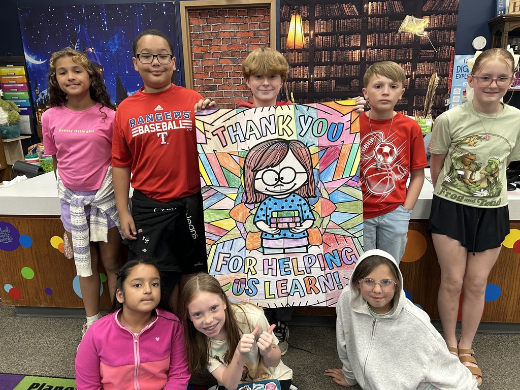 students holding signs for librarian