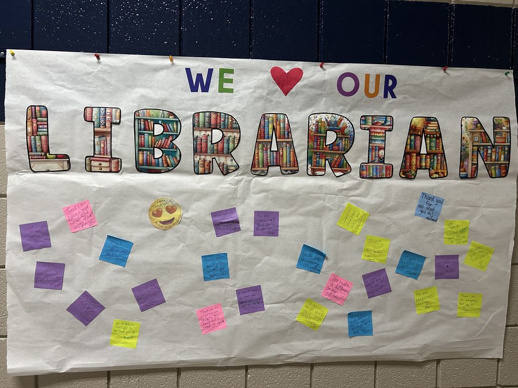 sign with sticky notes full of nice things for librarian