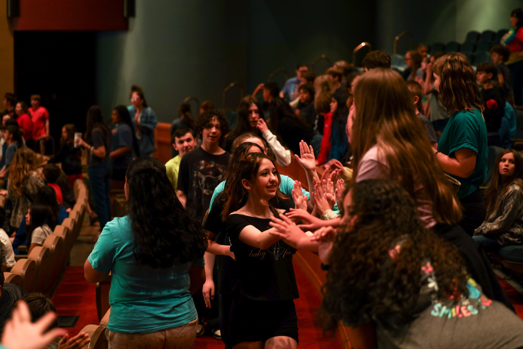 Junior high students hyping up the crowd