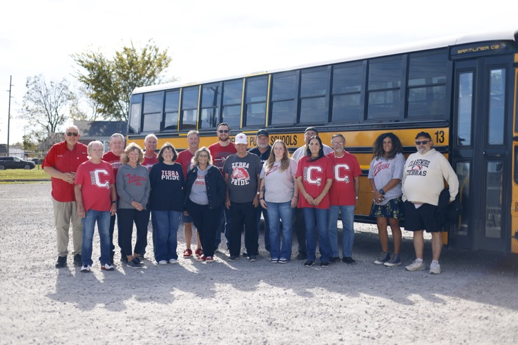Claremore bus drivers standing in front of a bus