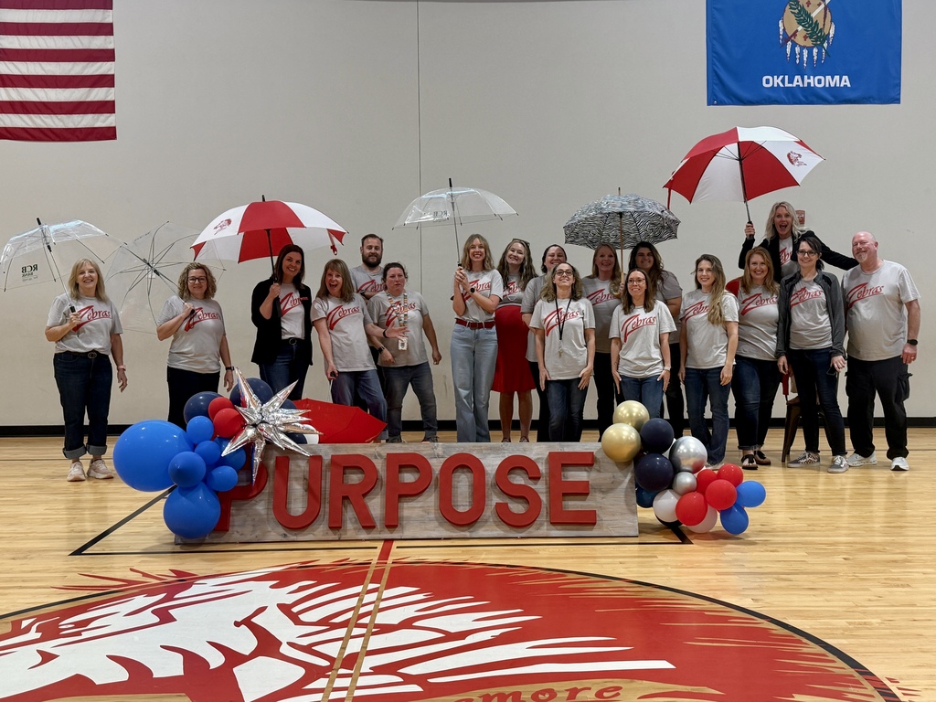 staff smilinhg with umbrellas