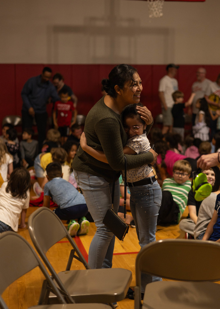 student and mother hugging