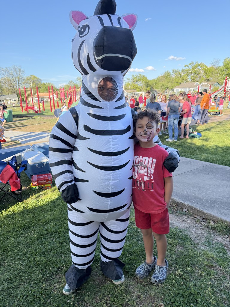 student smiling with zebra
