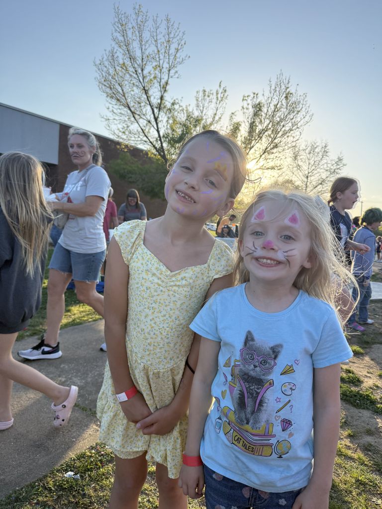 students smiling with face paint 