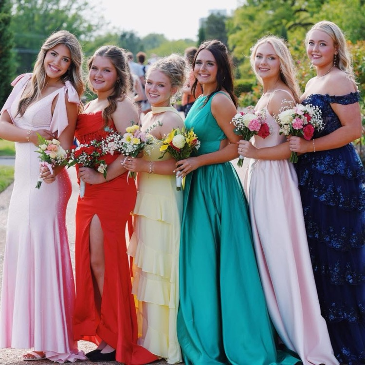 group of girls smiling with their prom bouquets, bright colors 