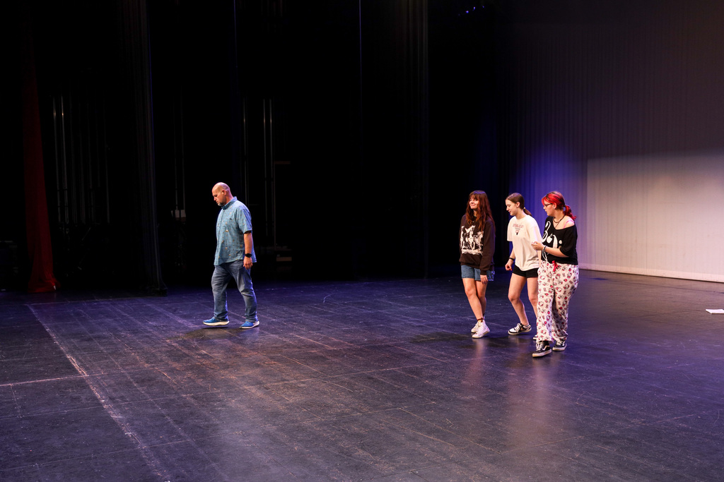 Director working with students at Footloose rehearsals.