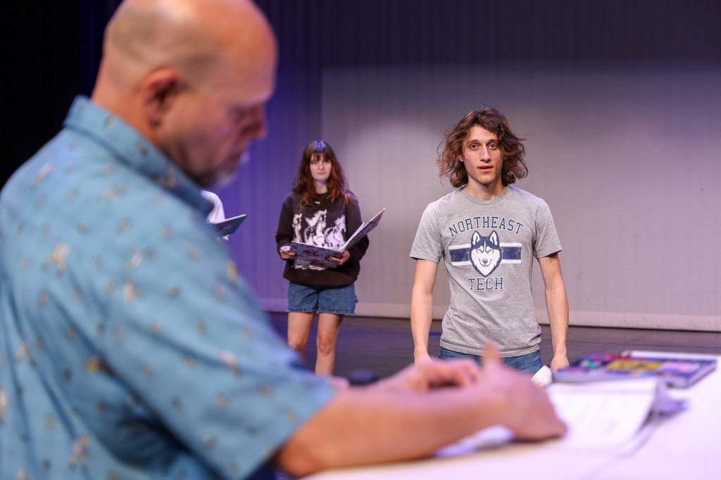 Director working with students at Footloose rehearsals.