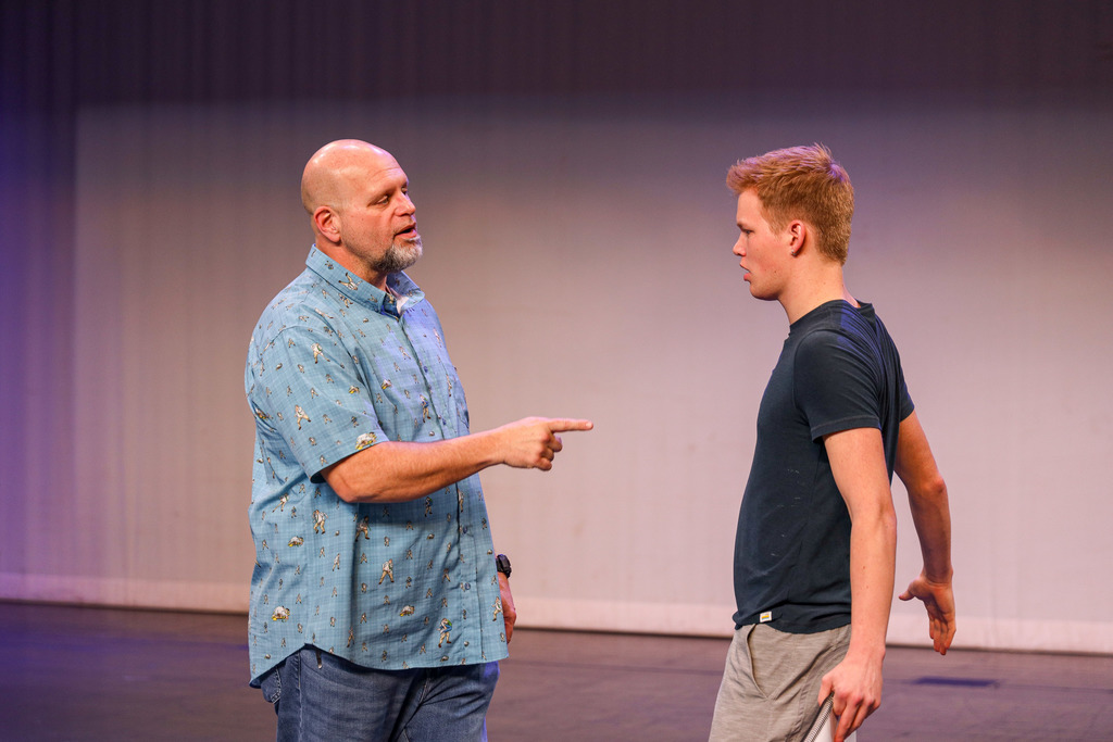 Director working with students at Footloose rehearsals.