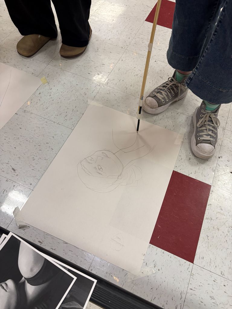 Student drawing during an art challenge