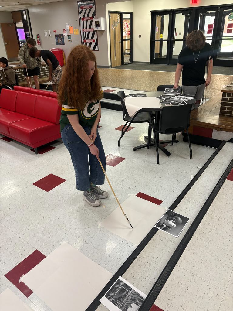 Student working on her art challenge during art.