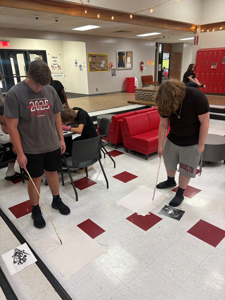 Two CHS art students working on their art challenge in the pit during their art class