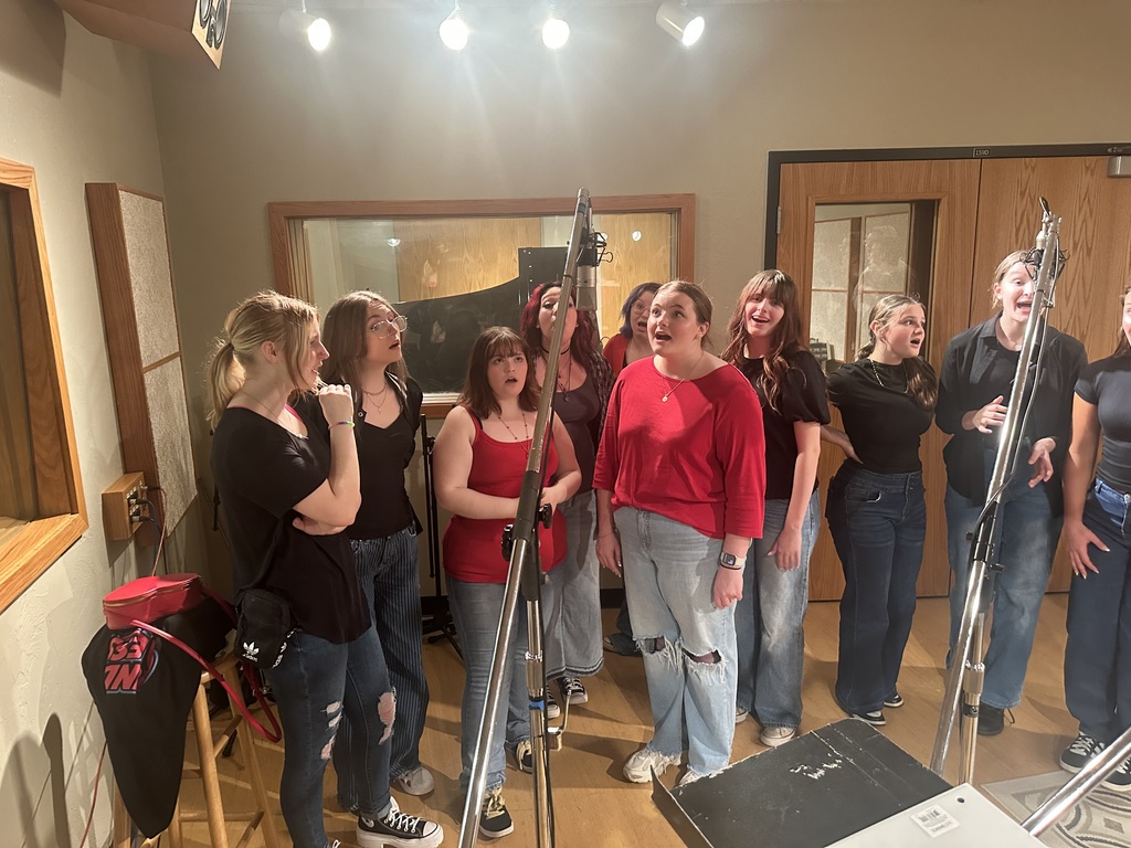 The ladies of Room 701 giving it their all in the recording studio.