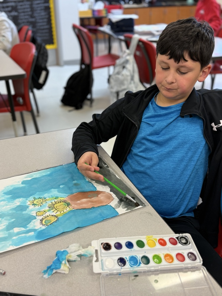 Student placing the final touches on their van Gogh inspired painting.