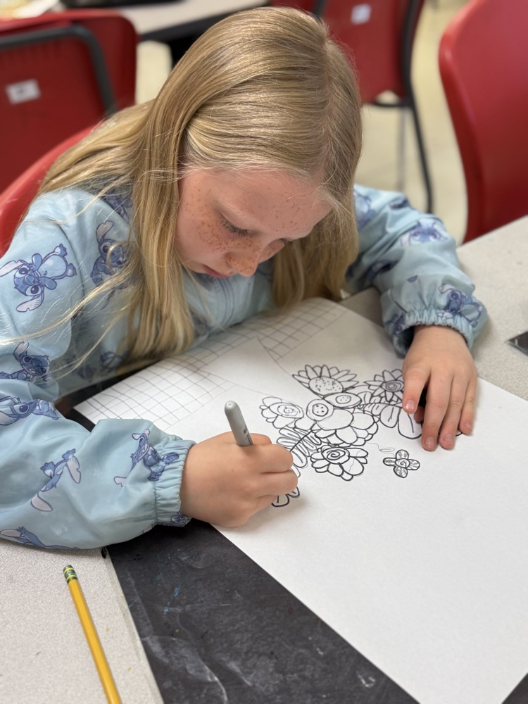 Student drawing beautiful flowers in art class.