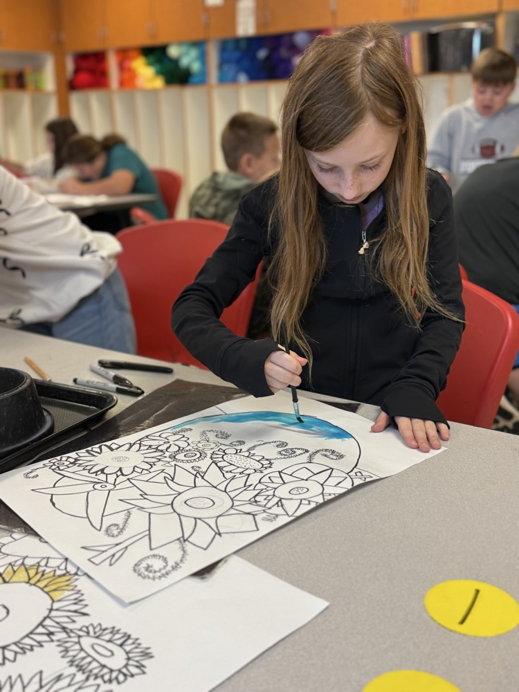 Student painting in art class on a van Gogh inspired painting