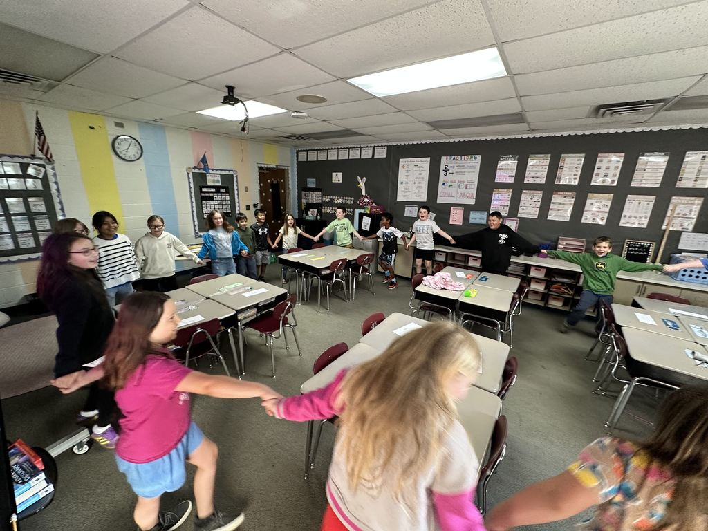 students holding hands, smiling
