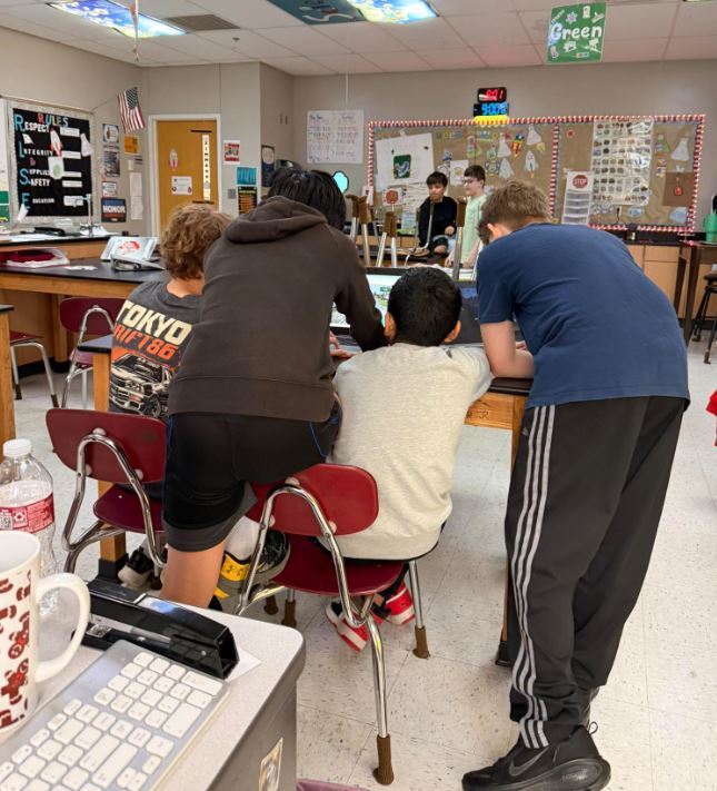 STUDENTS LOOKING AT GOOGLE EARTH