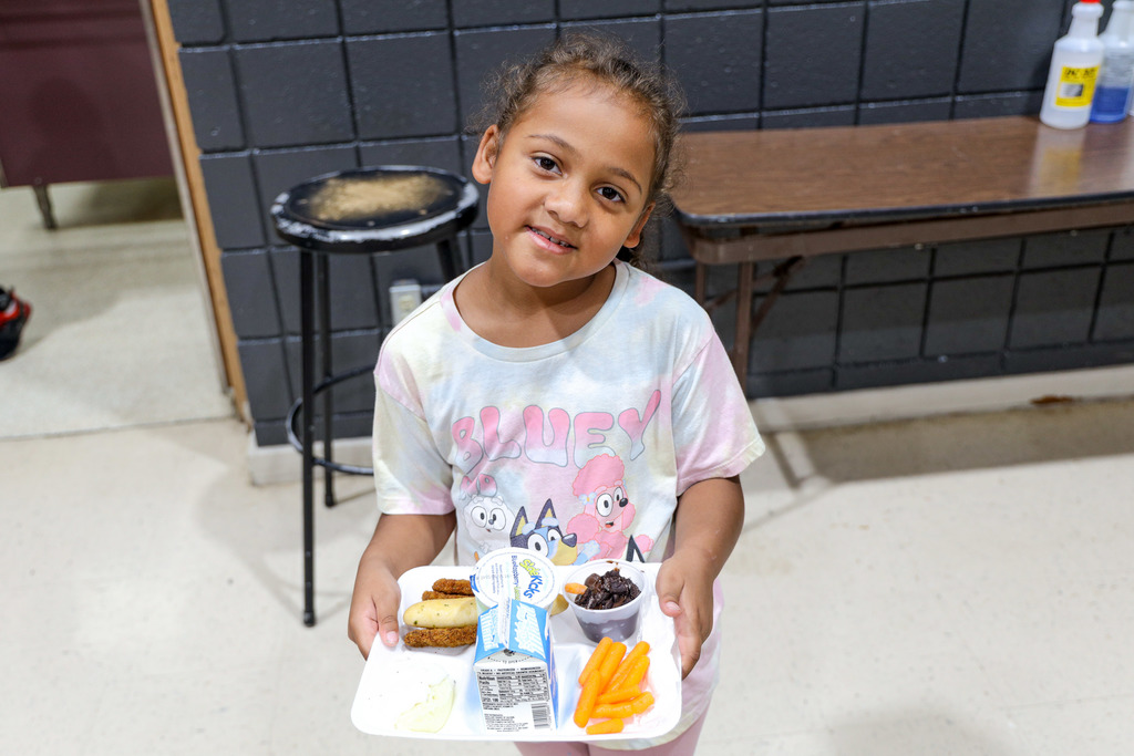 Elementary student with their lunch tray.