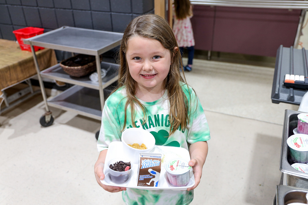 Elementary student with their lunch tray.