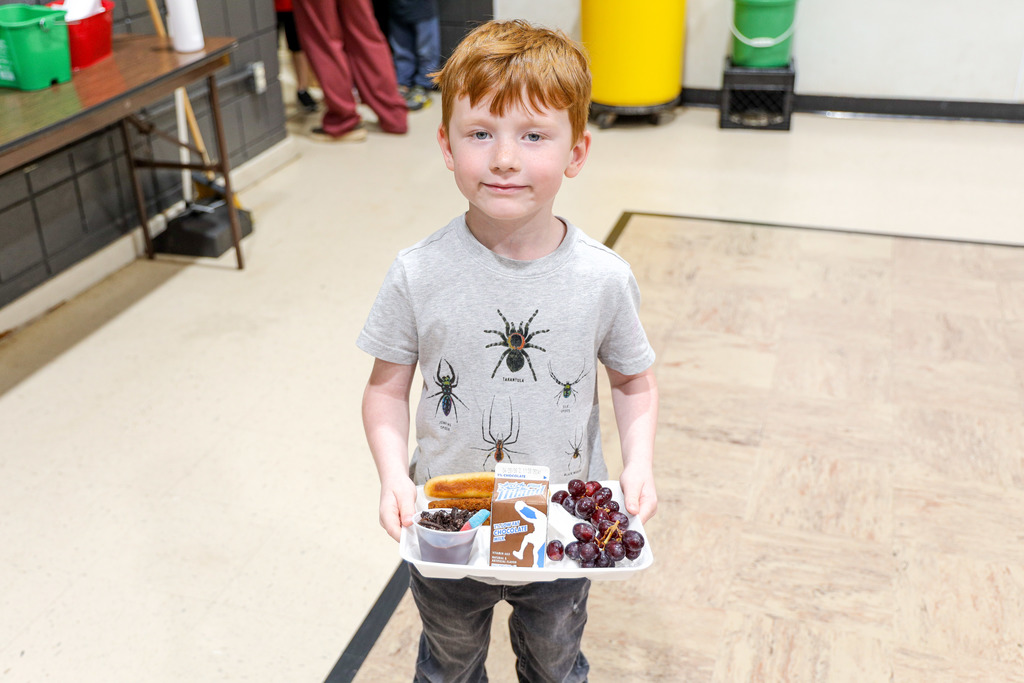 Elementary student with their lunch tray.
