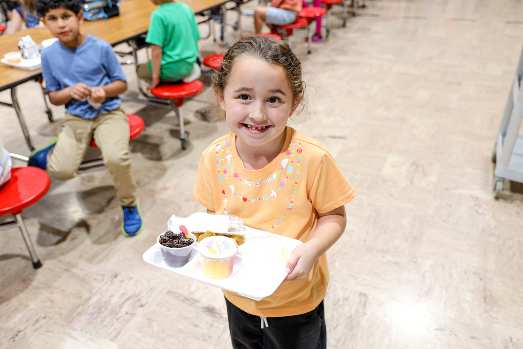 Elementary student with their lunch tray.