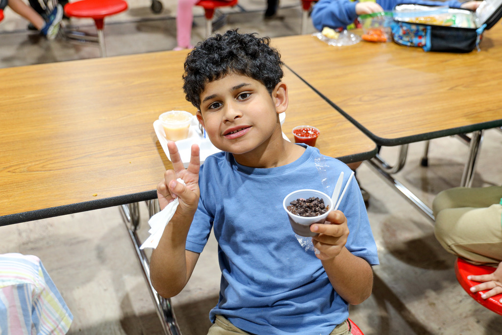 Elementary student with their lunch tray.