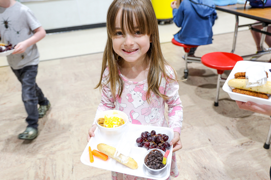 Elementary student with their lunch tray.