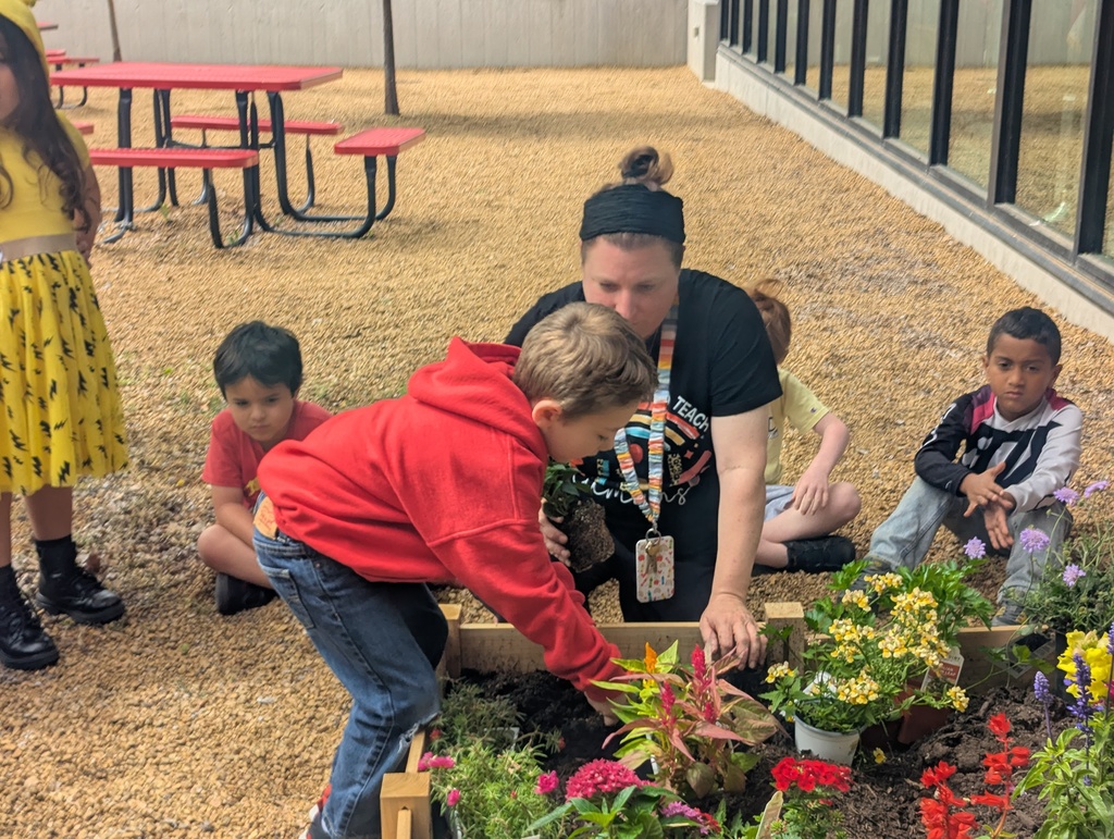 student helping in the garden