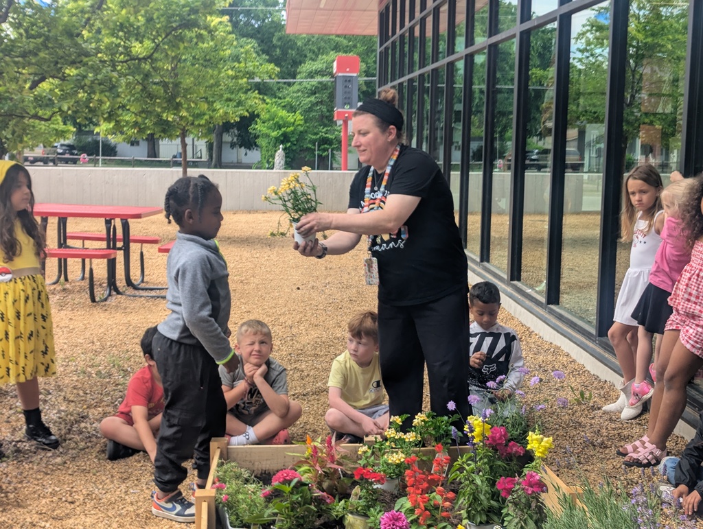 student helping in the garden