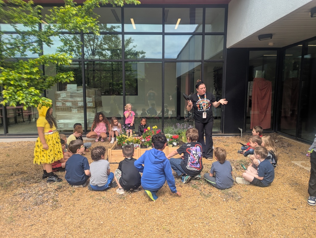 students sitting and learning about the garden