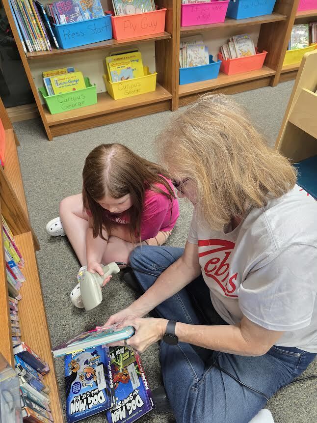 Brynn and Ms. Browning looking at books