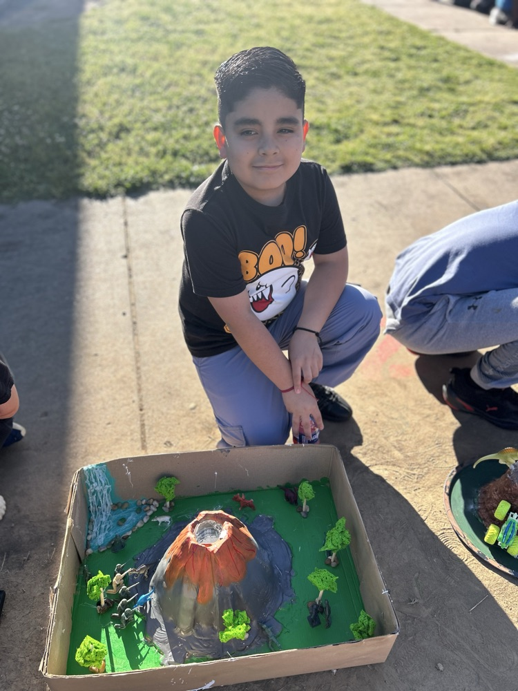 student with their volcano 