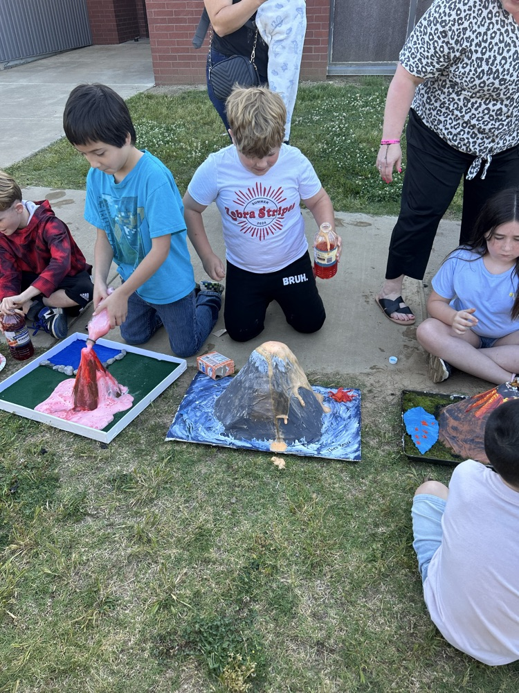 student with their volcano 