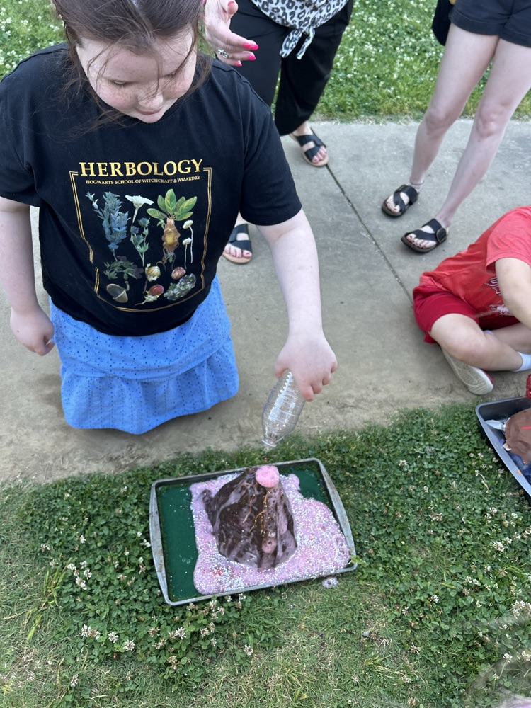 student with their volcano 