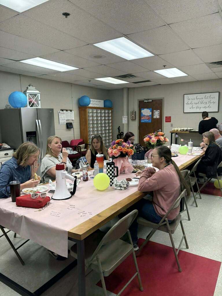 staff sitting and talking while eating