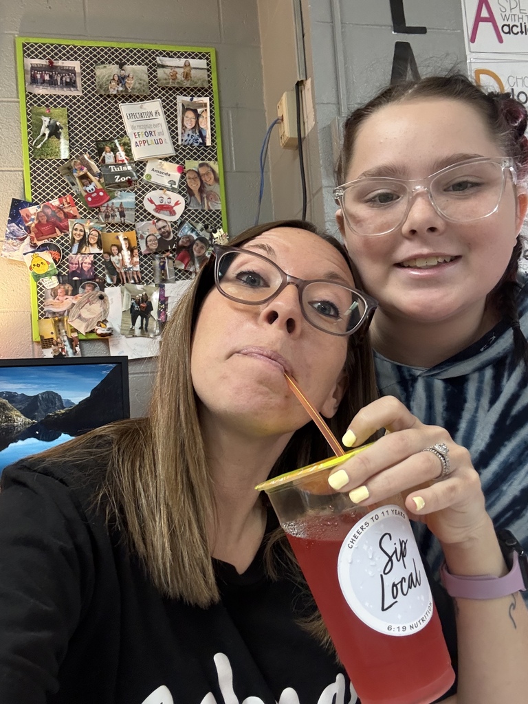 teacher enjoying tea, student next to student