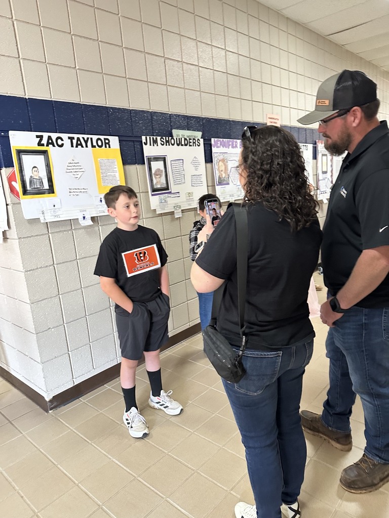 student smiling and performing for the wax museum for parents