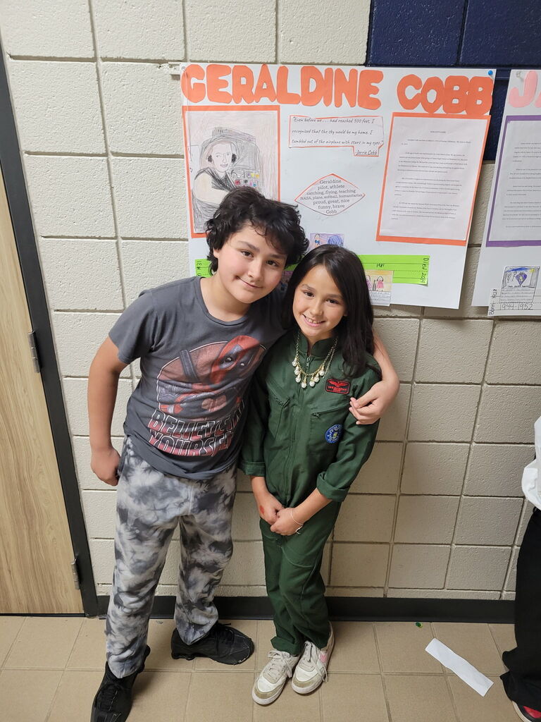 student smiling with sibling