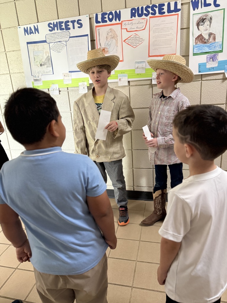 student ssmiling and performing for the wax museum