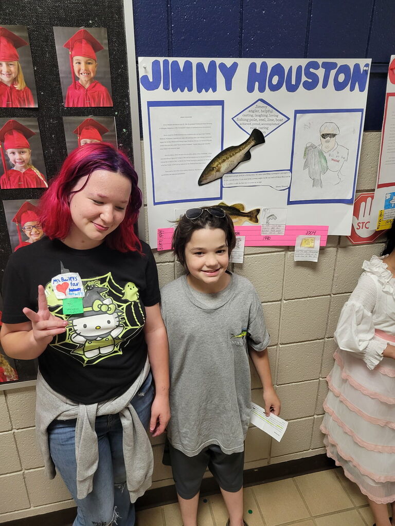 Student presenting for the wax museum with sibling