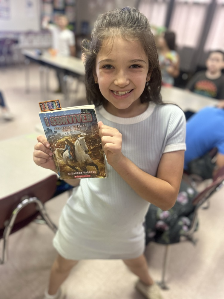 student holding book 