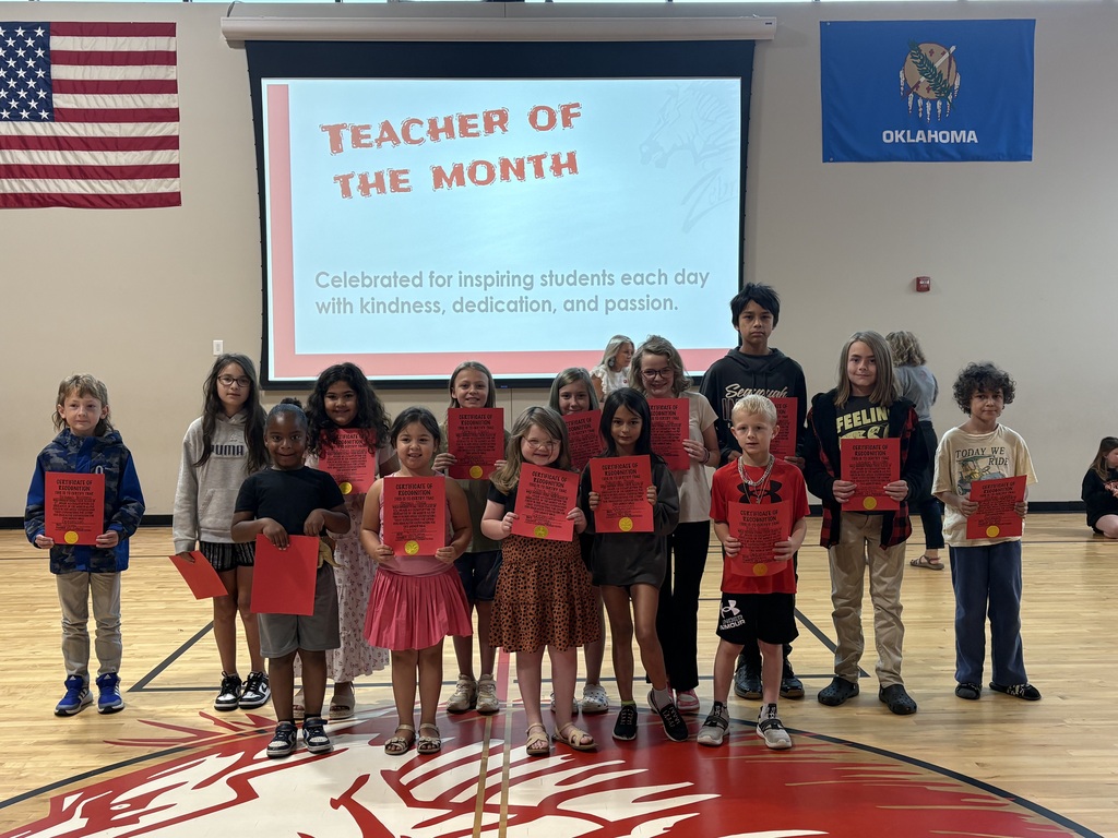students of the month holding a sign smiling