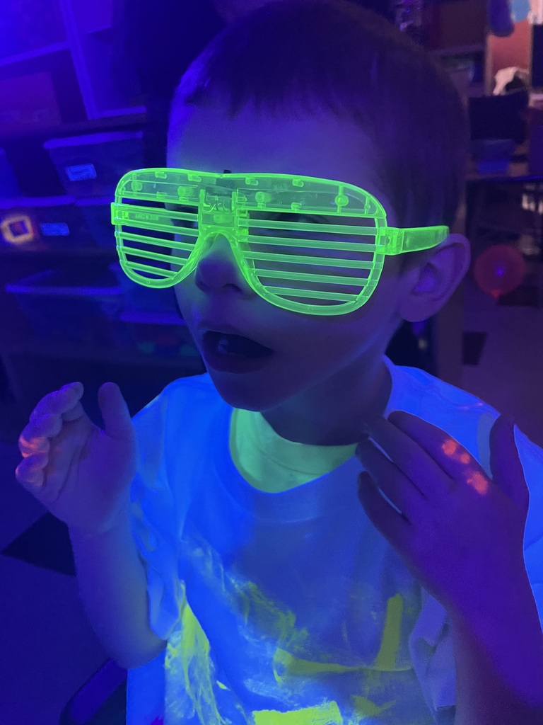 student wearing glow glasses