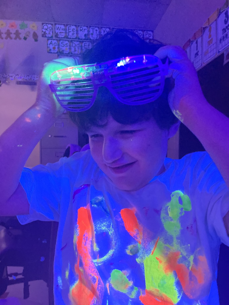 student taking off glasses and glowing