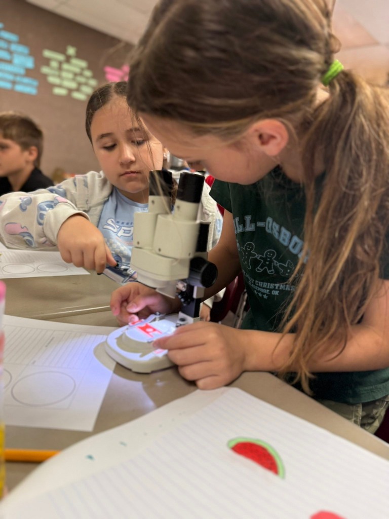 student using a microscope