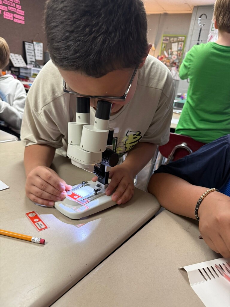 student using a microscope