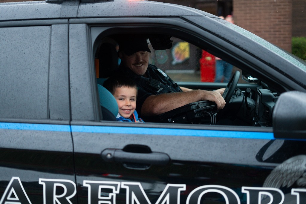 Logan riding with Officer Logan to school